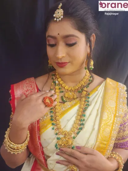 A student's work on a traditional bridal makeover. Notice the detailed eye makeup and the perfect placement of the bindi and maang tikka.