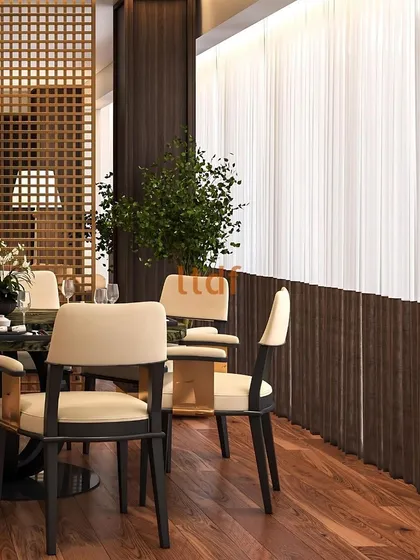 The interplay between the dining and living areas is defined by a wooden lattice screen, which provides a sense of separation without sacrificing openness. This element adds texture and architectural interest, contributing to the room's layered and thoughtful design.
