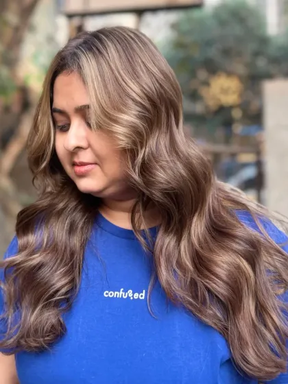 This client is wearing her new Ash Brown Highlights, a subtle and chic choice. The cool-toned elegance gives a soft, natural look.