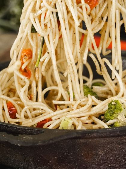 A close-up of our Farmer's Style Spaghetti, tossed with fresh broccoli and sun-dried tomatoes. It's a simple, rustic dish that's packed with flavor and goodness.