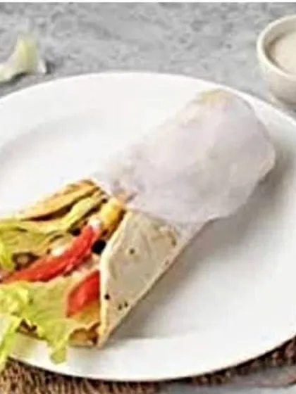 A look at my classic shawarma roll, loaded with fresh lettuce, tomatoes, and tender chicken, all wrapped in a soft, warm flatbread.