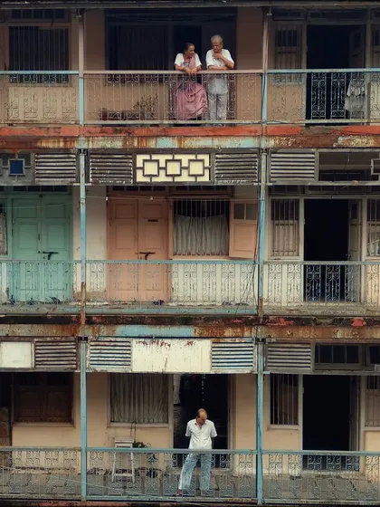 The architecture of old Mumbai buildings tells its own story. Here, I framed two generations on their balconies, capturing a quiet, vertical slice of life that shows the different lives lived within the same structure.