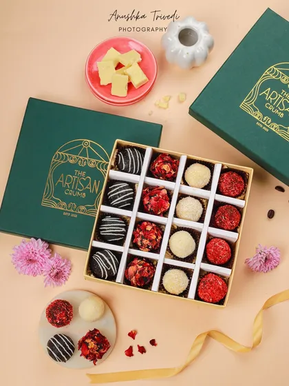 Another view of the artisanal truffle box, this time as a flatlay. This perspective gives a clear view of the beautiful packaging and the variety of truffles inside.