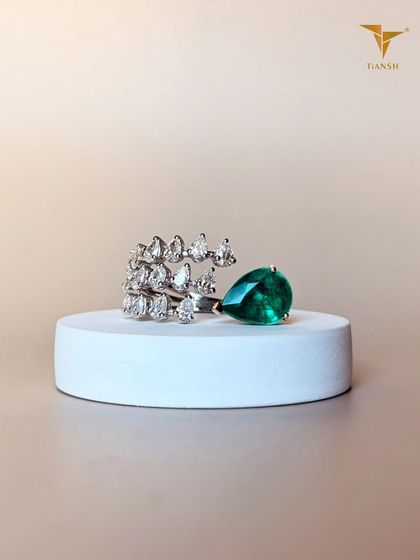 I believe in the magic of color and light. This pear-cut emerald ring is framed by diamonds that shimmer with every step you take.