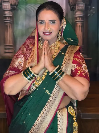 My client is ready for Ganpati celebrations in this classic Maharashtrian look. The makeup includes a traditional crescent bindi, a nath, and authentic jewelry.