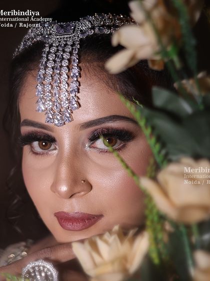 An artistic shot peeking through flowers, this demonstrates how to create makeup that photographs beautifully and tells a story.