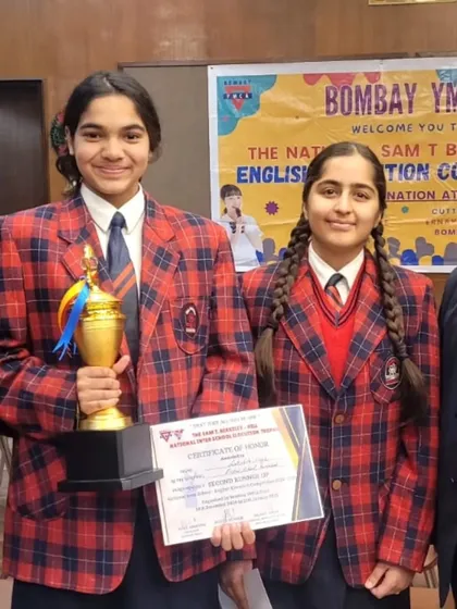 Lakshita Singh is a champion in and out of the pool, here winning a trophy in the English Elocution Contest. Discipline in sports translates to all areas of life.