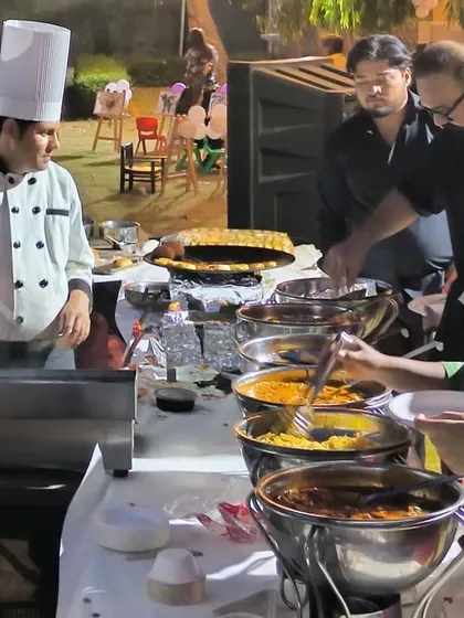 A young guest eagerly waiting as our chef prepares his plate at a live station. We enjoy creating a friendly and engaging atmosphere for guests of all ages.