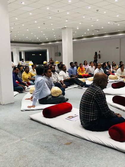 Participants deeply engaged in a listening and breathing exercise during the workshop. We teach foundational techniques that have benefits beyond just singing.