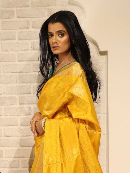 A close-up portrait from the shoot, showcasing the natural makeup and the traditional nath.