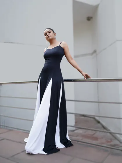 The full view of this stunning black and white gown. The contrasting panels create a visually interesting and flattering effect, making it a standout choice for a professional appearance.