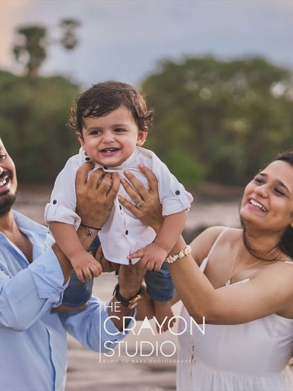 A joyful lift into the air brings out the biggest smiles. This happy, interactive portrait against the soft light of the beach captures the pure delight of being together as a family.