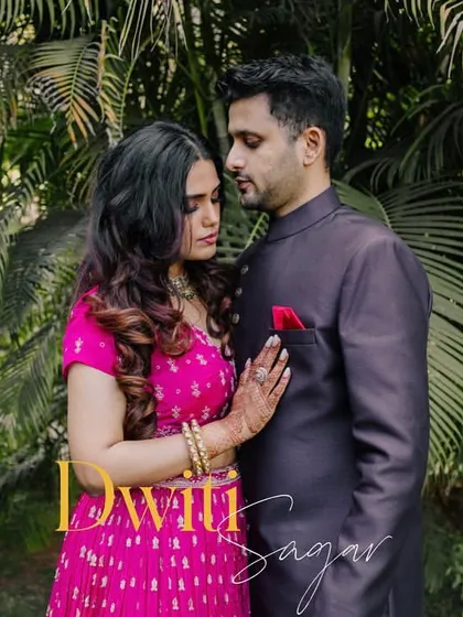An intimate portrait of a couple in a quiet embrace, set against lush green foliage. This shot captures a moment of calm connection.