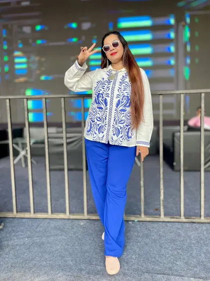 A confident pose at the Holi festival, ready for a full day of hosting.