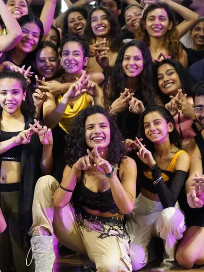 A close-up of the instructor and students, celebrating a successful class.