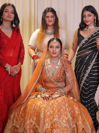 Posing with the bride and friends before the main event. My modern black saree provides a nice contrast to the bride's traditional orange lehenga.