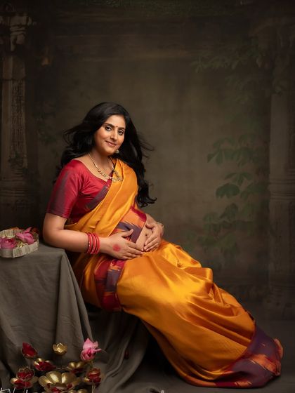 A direct and joyful portrait in her beautiful yellow and red saree. Her happiness and glow are the centerpiece of this image.