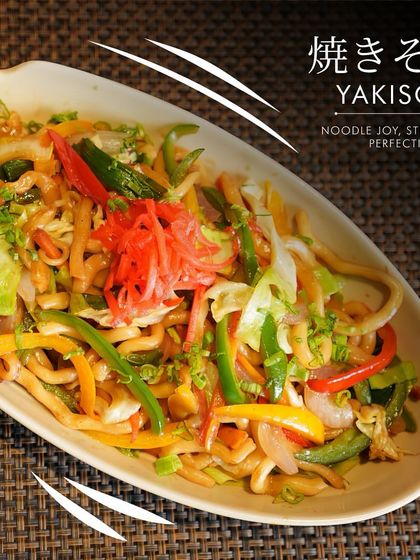 Our Yakisoba, garnished with pickled red ginger. This dish brings the lively flavors of Japanese street food straight to your table.
