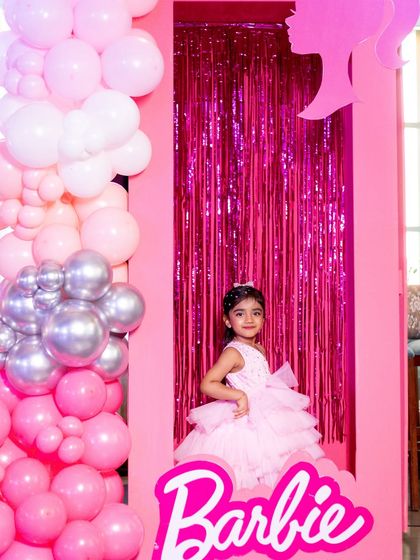 A picture-perfect moment with the birthday girl posing inside a life-sized Barbie doll box.