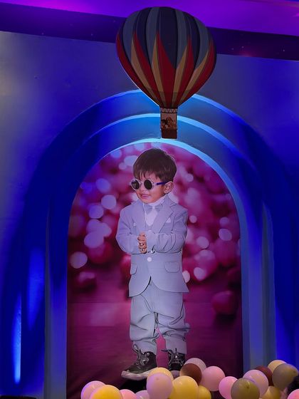 A close-up of the personalized backdrop, featuring a cool photo of the birthday boy inside a hot air balloon design.