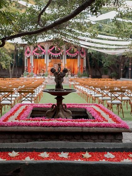 The fountain decorated with floating flowers, with the main ceremony stage in the background.