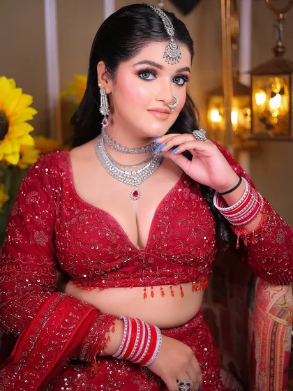 A close-up portrait focusing on the silver jewelry and bold makeup, creating a glamorous bridal look.