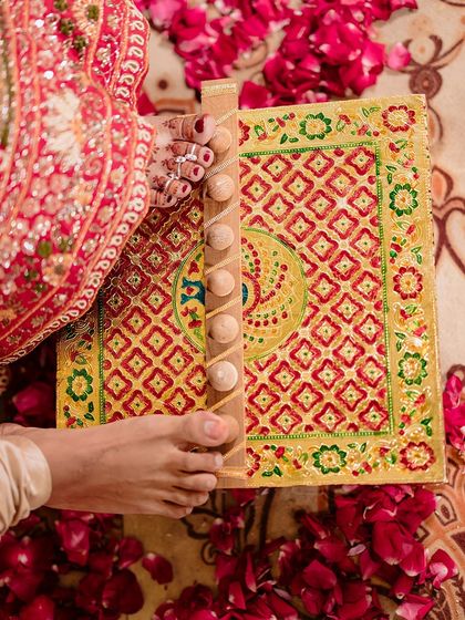 A detailed shot of a traditional Gujarati wedding ritual, focusing on the hands and the beautifully decorated elements of the ceremony.