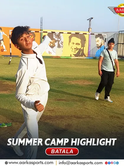 A young player practices his bowling follow-through at the summer camp, with the inspiring murals in the background.