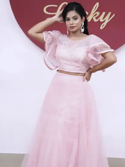A confident pose showing the full outfit. The soft pink monochrome look is very on-trend and photographs beautifully.