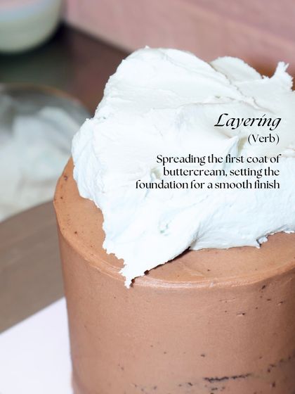 It all starts with Layering. Spreading the first coat of buttercream, also known as a crumb coat, sets the foundation for a smooth finish.