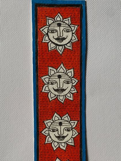 A row of smiling suns adorns this cheerful Madhubani bookmark. The sun is a powerful symbol of life and energy in this ancient art form.