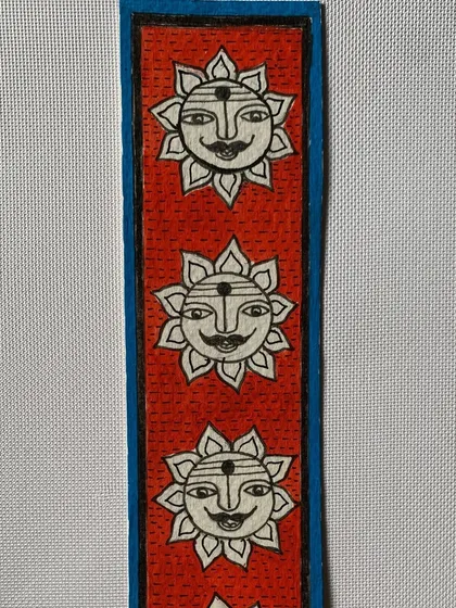A row of smiling suns adorns this cheerful Madhubani bookmark. The sun is a powerful symbol of life and energy in this ancient art form.