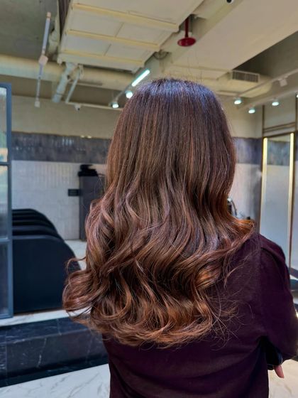 The final result of the chocolate brunette transformation. The color is rich and warm, and the soft waves show off the beautiful, glossy finish.