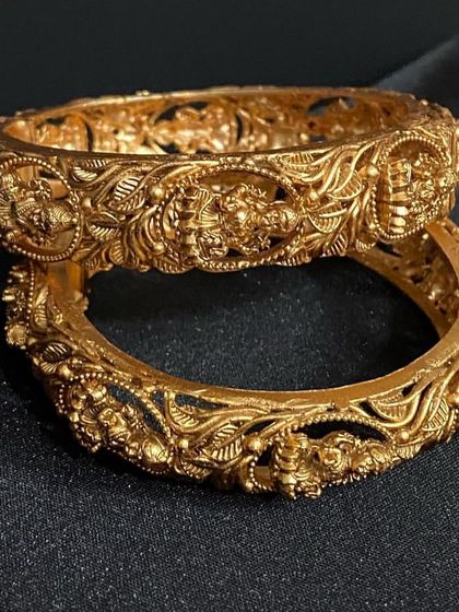 These beautifully carved antique bangles feature goddess Lakshmi motifs. They are the perfect accessory to complement a full temple jewellery set.