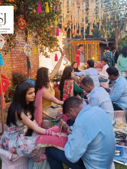 A lively Mehandi event where guests enjoy getting their henna done in a beautifully decorated outdoor setting. I ensure the entire space feels festive.