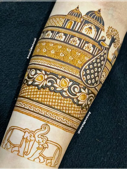The beginning of a beautiful bridal arm design. This image shows the outline of elephants and a peacock near a palace, setting the stage for an intricate masterpiece.