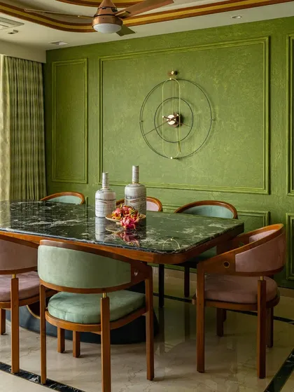 A full view of the dining set against the elegant olive green walls.