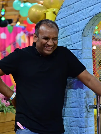 It's not just the kids who have fun. This photo captures a dad sharing a laugh and enjoying the party atmosphere.