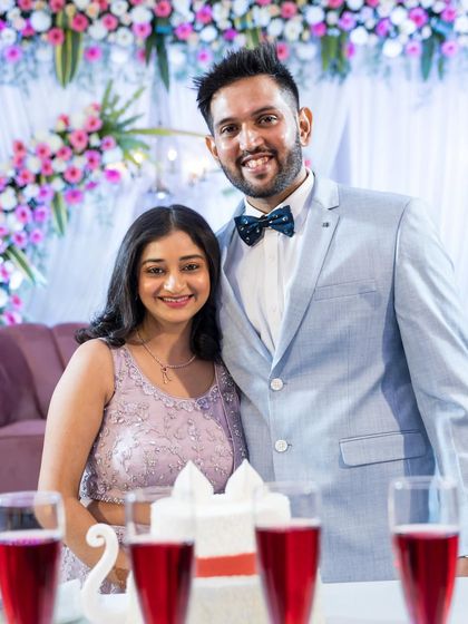 A classic portrait of the newly engaged couple by their cake. A beautiful memory of the celebration, complete with smiles and sparkling drinks.