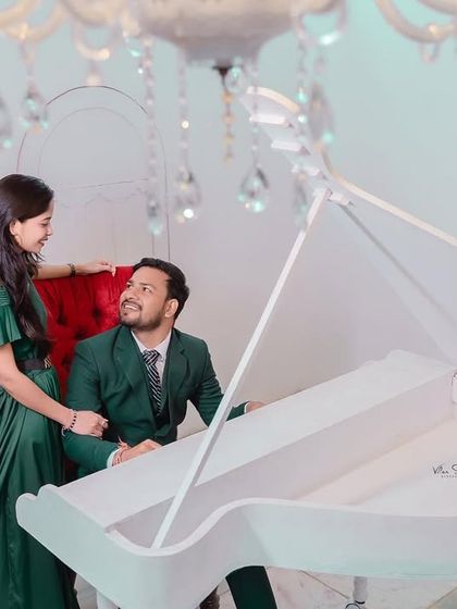 A sweet, interactive moment at the grand piano. The couple shares a look, creating a photo that feels both elegant and personal.