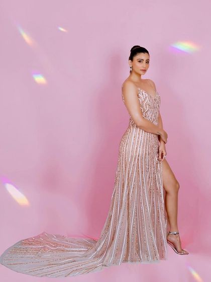 A classic red carpet pose, this photo of Daisy Shah showcases the full effect of the gown, her hairstyle, and the overall styling. It's a perfect shot for event coverage and press releases.