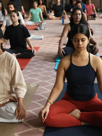 A moment of shared stillness and meditation during a group practice. This is where we quiet the mind after the physical work, connecting to the deeper benefits of yoga.