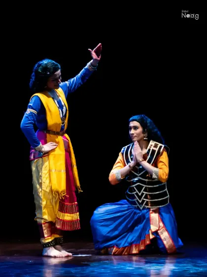 Another powerful moment from the dance drama, showing a scene of reverence and dialogue. This demonstrates my ability to interact with other performers to create a compelling narrative.