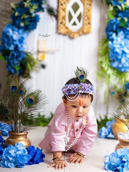 A little Krishna on the move! This shot captures a moment of exploration and curiosity amidst the beautiful festive decorations.