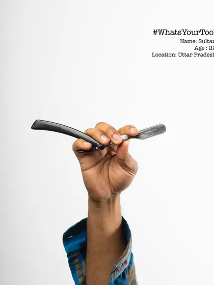 This is Sultan, a 22-year-old barber, holding his razor for the "What's Your Tool" series. The project aimed to create appreciation for the tools that enable us to earn our livelihood.