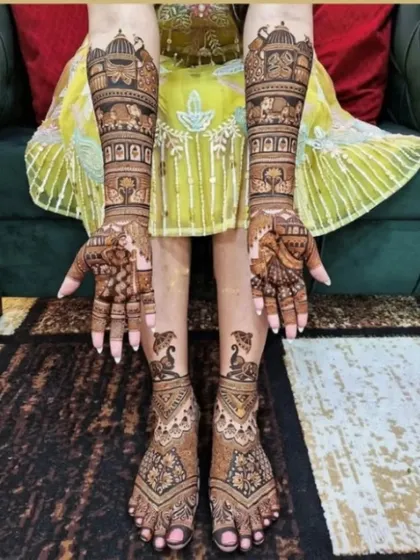 A complete bridal look with matching designs for both hands and feet, featuring elephants, peacocks, and palace architecture.