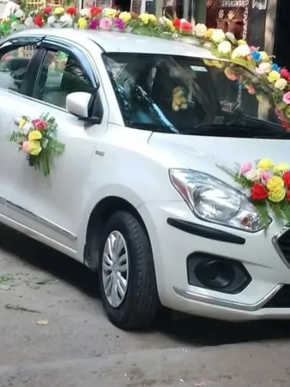 We also offer wedding car decorations using high-quality artificial flowers. This Maruti Dzire is decorated with vibrant, multi-colored floral bouquets for a bright and festive look suitable for the baraat.