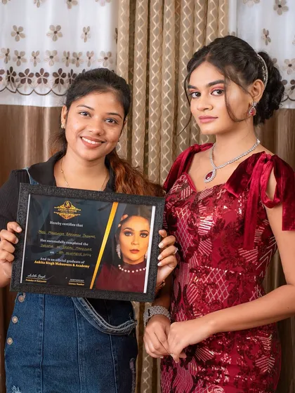 A student and her model showcasing a glamorous reception look for the portfolio. My courses cover everything from traditional bridal to modern party makeup.