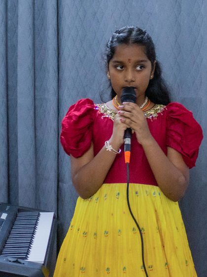 A young singer in traditional attire at the BEML open mic. These events are a celebration of musical and cultural diversity.