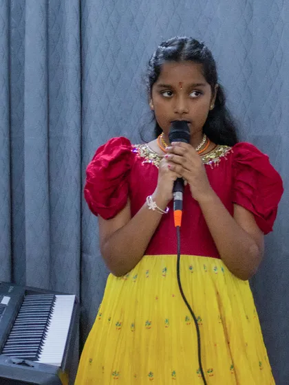 A young singer in traditional attire at the BEML open mic. These events are a celebration of musical and cultural diversity.